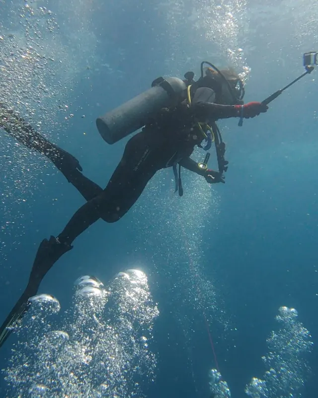 Catherine scuba diving with a camera in the Galápagos